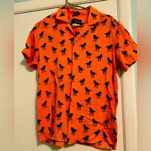 A new take on a Hawaiian shirt!
Peach and Navy T Rex button down!
